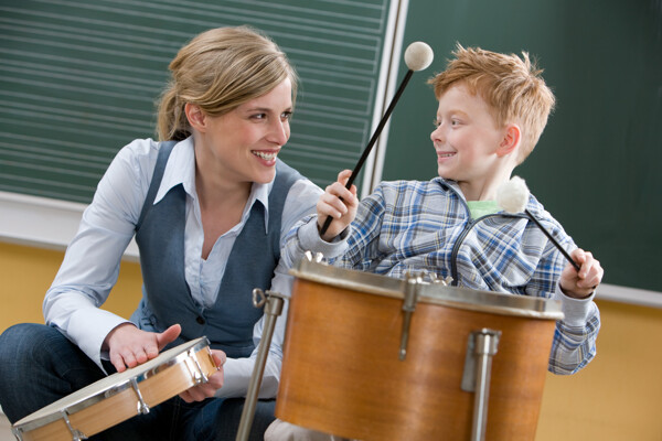 外国老师教小男孩乐器图片